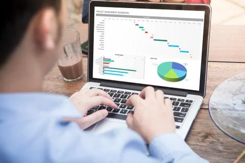 Young man working with excel project dashboard using laptop / computer  Stock Photos