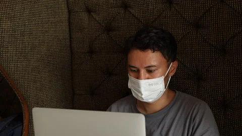 Young man working in a face mask in co-working diring lockdown. Stock Footage 161780949