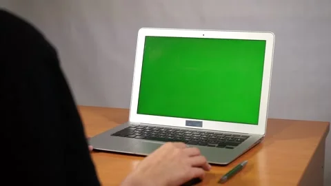 A young man working on a green screen computer Video stock 164059128