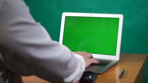 A young man working on a green screen computer Video stock 164059398