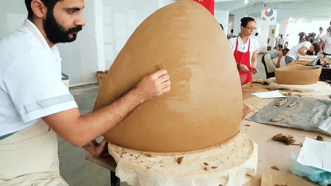 Young man working on his sculpture at the 12th International Eskisehir Terra Stock Footage 104032541