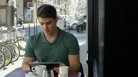 Young man working on his tablet while at a local cafe. Stock Footage 63031268