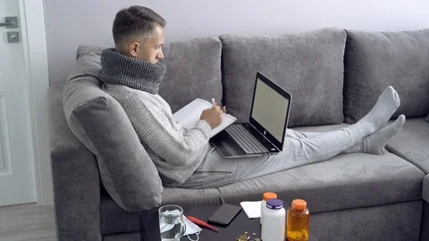 Young man working from home during illness. Online education. Stock Footage 111747679