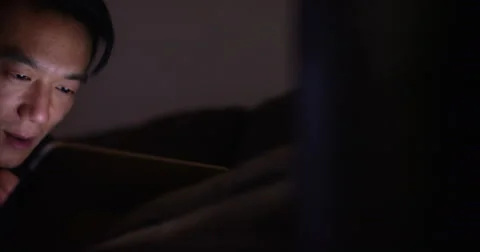 Young man working from home on his digital tablet late into the night. Stock Footage 58664395