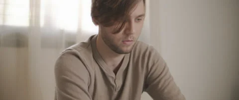 A young man working from home, in his bedroom. Close up, slow motion, BMPCC 4 Stock Footage 135095250