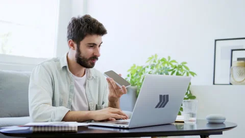 Young man working from home talking on the phone Stock Footage 142535148