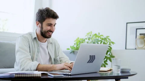 Young man working from home typing on laptop Stock Footage 142531837