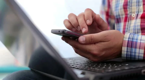 Young man working from home using smart phone and notebook Video stock 67112805