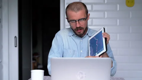 Young man is working from home using videoconference with colleagues. Stock Footage 135981460