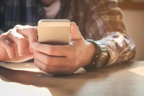Young man working from home using smart phone Stock Photos