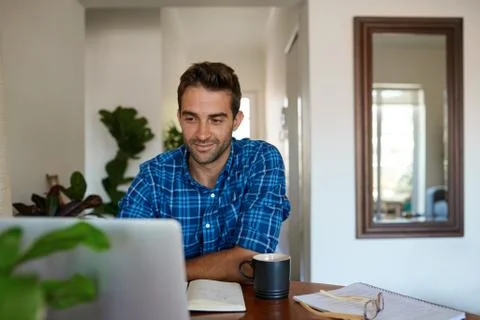Young man working from home using a laptop Foto stock