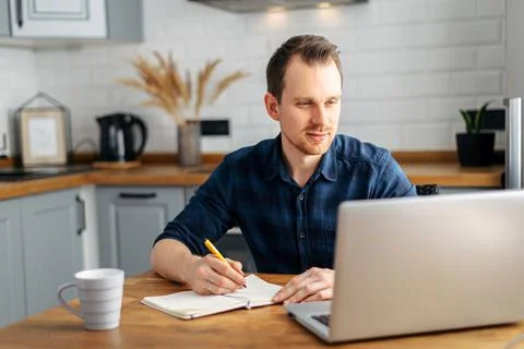 Young man working from home using laptop. Foto stock