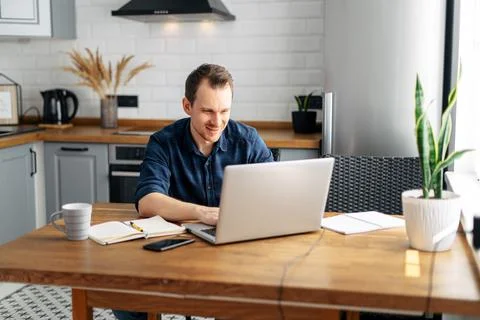 Young man working from home using laptop. Foto stock