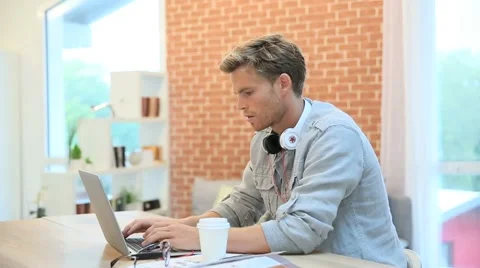 Young man working on laptop computer Stock Footage 43301689
