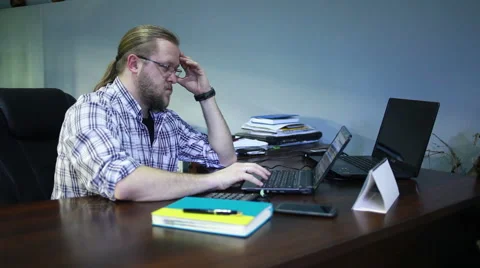 Young man  working on laptop computer in the office, steadicam Video stock 48400181