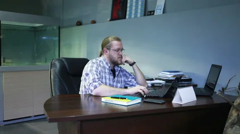 Young man  working on laptop computer in the office, steadicam Stock Footage 48400412