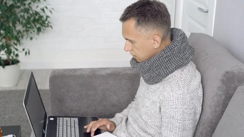 Young man is working on a laptop computer at home Stock Footage 111755130