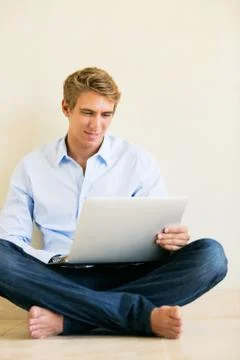 Young man working on laptop computer at home Stock Photos