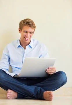 Young man working on laptop computer at home Stock Photos