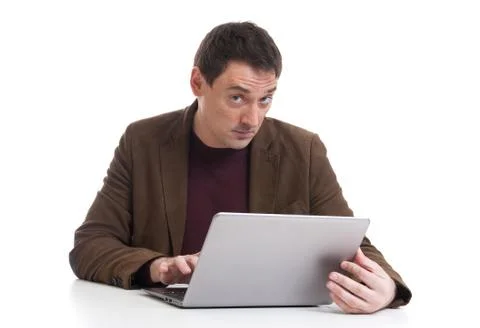 Young man working on laptop computer Stock Photos