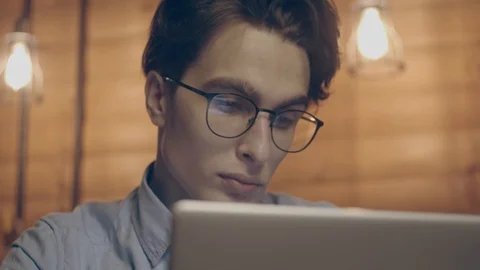 Young man working with laptop Stock Footage 125080332