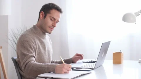 Young man working on laptop Stock Footage 232993315