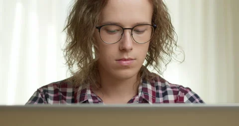 A young man is working on a laptop on the Internet.  Stock Footage 198066944