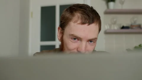 Young man working on laptop in the kitchen. Stock Footage 262949255
