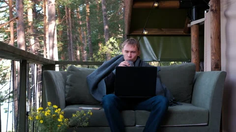 Young Man Working on Laptop Outside Glamping Tent Stock Footage 139349935