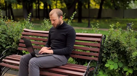 The Young Man Working on a Laptop in the Park Video stock 50995014