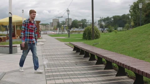 Young man working on laptop in the park Stock Footage 66692091