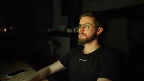 Young Man Working Late at Home in Dim Light; Freelance work Stock Footage 320395238