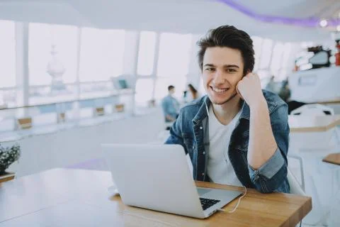 Young man working on a macbook or laptop in cafe Stock Photos