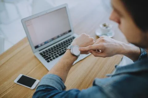 Young man working on a macbook or laptop in cafe Stock Photos