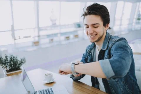 Young man working on a macbook or laptop in cafe Stock Photos