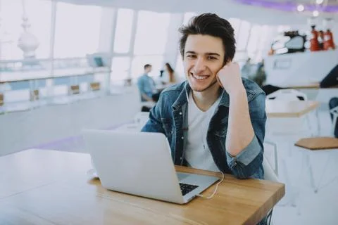 Young man working on a macbook or laptop in cafe Stock Photos