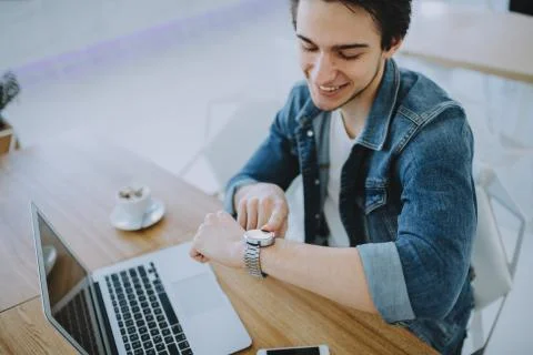 Young man working on a macbook or laptop in cafe Stock Photos