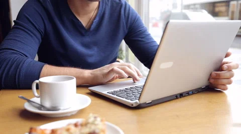 Young man working on modern laptop in cafe Stock Footage 67862673
