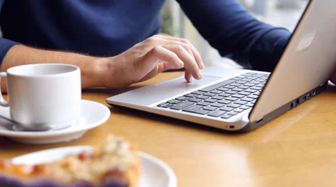 Young man working on modern laptop in cafe Stock Footage 67862709