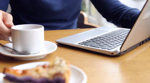 Young man working on modern laptop in cafe Stock Footage