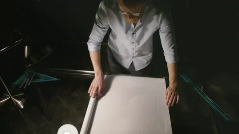 Young Man Working In Modern Office At Night. Architect Opens The Drawing Paper. Vídeos de archivo 113111350