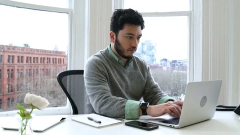 Young man working in an office 動画素材 77080763