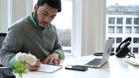 Young man working in an office 動画素材 77080841