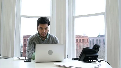 Young man working in an office 動画素材 77080914