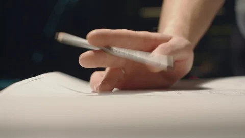 Young Man Working In Office At Night. Holding A Pencil In Hand, Viewing A Stock Footage 113109878