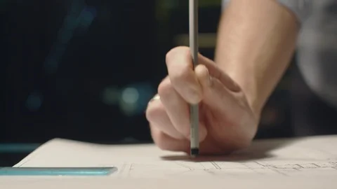 Young Man Working In Office At Night. Holding A Pencil In Hand. Knocking By Stock Footage 113110010