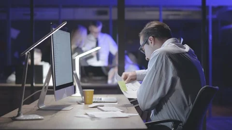Young man working in office at night. Stock Footage 125687101