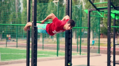 Young man working out on a bar at a sports arena Stock Footage 139808928