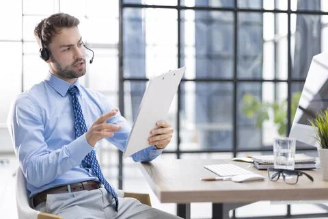 Young man is working with papers while sitting in the office. Foto stock