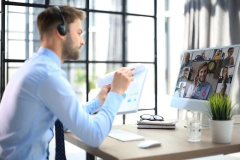 Young man is working with papers while sitting in the office. Successful Stock Photos